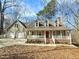 Charming two-story home with a welcoming front porch and a two-car garage at 2024 Fox Den, Clayton, NC 27527