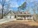 Beautiful home featuring a covered front porch and an attached two-car garage at 2024 Fox Den, Clayton, NC 27527