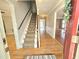 Inviting foyer with hardwood floors, a carpeted staircase, and an open layout at 2024 Fox Den, Clayton, NC 27527