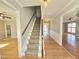 Home foyer featuring hardwood floors, carpeted stairs, and natural light at 2024 Fox Den, Clayton, NC 27527