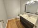 Charming half bath featuring modern vanity, new fixtures, and wood floors at 2024 Fox Den, Clayton, NC 27527