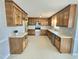 Bright kitchen featuring wooden cabinets, stainless steel appliances, and a large window at 2024 Fox Den, Clayton, NC 27527