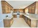 Well-equipped kitchen featuring ample wooden cabinets, a stainless steel appliances, and a large window at 2024 Fox Den, Clayton, NC 27527