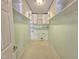 Laundry room features shelving, washer and dryer hookups, and utilitarian tile floor at 2024 Fox Den, Clayton, NC 27527