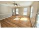 Spacious living room featuring hardwood floors, neutral paint, chair rail, and lots of natural light at 2024 Fox Den, Clayton, NC 27527