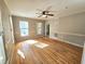 Spacious living room with hardwood floors, natural light, and a ceiling fan at 2024 Fox Den, Clayton, NC 27527
