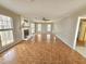 Large living room with a brick fireplace and plenty of bright light from the windows at 2024 Fox Den, Clayton, NC 27527