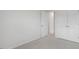 Bedroom with neutral carpeting, closet and white door at 208 Starlight St, Sanford, NC 27330