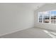Bright and airy bedroom with large window offering natural light and neutral carpeting at 208 Starlight St, Sanford, NC 27330