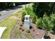 Community sign surrounded by beautiful landscaping, and green grass at 208 Starlight St, Sanford, NC 27330