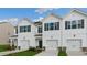 Beautifully designed townhomes boast white siding, black shutters and single car garages at 208 Starlight St, Sanford, NC 27330