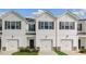 Charming townhomes featuring white siding, black shutters and a single-car garage at 208 Starlight St, Sanford, NC 27330