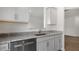 Kitchen with gray cabinets, granite countertops, stainless steel appliances, and a sink at 208 Starlight St, Sanford, NC 27330