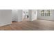 Open living space with wood-look floors and a view of the modern kitchen at 208 Starlight St, Sanford, NC 27330