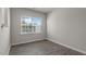 This bedroom features wood floors and a large window with natural light at 216 Starlight St, Sanford, NC 27330