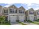 Charming two-story tan townhome with a single-car garage and manicured lawn at 216 Starlight St, Sanford, NC 27330