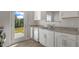 Bright kitchen featuring stainless steel appliances and backyard access at 216 Starlight St, Sanford, NC 27330