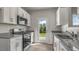 Modern kitchen with stainless steel appliances, granite countertops and outside view at 216 Starlight St, Sanford, NC 27330