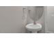 Clean powder room with pedestal sink, mirror, and neutral wall color at 216 Starlight St, Sanford, NC 27330