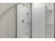Shower with glass door, shower head, and tiled walls at 216 Starlight St, Sanford, NC 27330