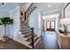 Grand foyer with hardwood floors, a staircase with wood railing, and lots of natural light at 223 Harvester Rd, Angier, NC 27501