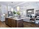 Gourmet kitchen with stainless steel appliances, stylish pendant lighting, and an island with seating at 223 Harvester Rd, Angier, NC 27501