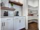 Charming butler's pantry with marble backsplash, floating wood shelves, and walk-in pantry at 223 Harvester Rd, Angier, NC 27501