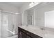 Modern bathroom featuring a double vanity, quartz countertop, and glass shower at 260 Chesapeake Commons St # 156, Garner, NC 27529