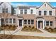 Charming brick townhome exterior with manicured landscaping and inviting entryway at 260 Chesapeake Commons St # 156, Garner, NC 27529