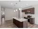 Kitchen with an island, stainless steel appliances, and dark wood cabinets at 260 Chesapeake Commons St # 156, Garner, NC 27529