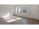 Bright living room with wood floors and abundant natural light from large windows at 260 Chesapeake Commons St # 156, Garner, NC 27529