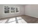 Sunlit living room featuring wood flooring, white trim and neutral paint color at 260 Chesapeake Commons St # 156, Garner, NC 27529