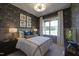 Cozy bedroom with accent wallpaper, and natural lighting from the bright window at 306 Golden Leaf Farms Rd, Angier, NC 27501