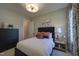 Comfortable bedroom featuring soft lighting, a decorative lamp, and stylish furniture at 306 Golden Leaf Farms Rd, Angier, NC 27501