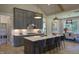 Modern kitchen featuring an island with seating, stainless steel appliances, and stylish gray cabinetry at 306 Golden Leaf Farms Rd, Angier, NC 27501