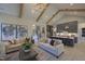 Spacious living room with stylish sofas, a decorative rug, and views into the modern kitchen area at 306 Golden Leaf Farms Rd, Angier, NC 27501