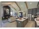 Open-concept living room with a fireplace, exposed beams, chandelier, and seamless flow to the kitchen at 306 Golden Leaf Farms Rd, Angier, NC 27501