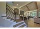 Open concept staircase leading to a modern kitchen and dining area with bright windows at 306 Golden Leaf Farms Rd, Angier, NC 27501