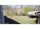Backyard featuring a covered area and a mix of natural greenery, offering a functional outdoor space at 3117 Cheek Rd, Durham, NC 27704