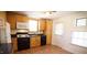 Practical kitchen with wood cabinets, essential appliances, and a well-lit area by the window at 3117 Cheek Rd, Durham, NC 27704