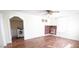 Bright living room with hardwood floors, white trim, a decorative fireplace, and a laundry room alcove at 3117 Cheek Rd, Durham, NC 27704
