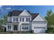 Beautiful two story traditional home with white siding, black shutters and a two car garage at 332 Ivy Ridge Rd, Chapel Hill, NC 27516