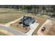 Aerial view of a modern home with beautiful landscaping, a long driveway, and a spacious yard at 35 Wheatfield Ln, Youngsville, NC 27596