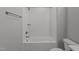 Bright bathroom with white subway tile in shower/tub, a neutral tile floor, and a sleek toilet at 35 Wheatfield Ln, Youngsville, NC 27596