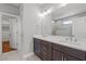 Bathroom with double vanity, a large mirror, and tiled floors at 35 Wheatfield Ln, Youngsville, NC 27596