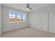 Bedroom with carpet flooring, large windows bringing in plenty of natural light, and a ceiling fan at 35 Wheatfield Ln, Youngsville, NC 27596