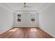 Bright bedroom features hardwood flooring, tray ceilings and dual windows at 35 Wheatfield Ln, Youngsville, NC 27596