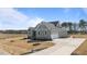 View of craftsman home featuring a large driveway leading to a two-car garage and an expansive lawn at 35 Wheatfield Ln, Youngsville, NC 27596