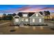 Charming craftsman home featuring stone accents, neutral siding, black metal roof accents, and manicured landscaping at 35 Wheatfield Ln, Youngsville, NC 27596