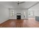 Cozy living room featuring hardwood floors, a gas fireplace with mantel, and lots of natural light at 35 Wheatfield Ln, Youngsville, NC 27596